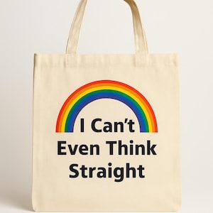May include: Beige tote bag with a rainbow graphic and the text "I Can't Even Think Straight" in black. The bag has two handles and is made of a canvas-like material.