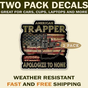 May include: Two-pack decals featuring an American flag design with the text "American Trapper." The image includes a bear trap and the phrase "Judged by many... Apologize to none." The decals are weather resistant and suitable for cars, cups, and laptops.