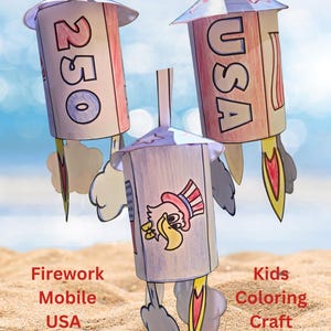 May include: Three handmade paper firework mobiles with the text "USA" and "250". The rockets are red, white, and blue, with a cartoon eagle illustration. The background is a sandy beach and blue sky. The image also includes the text "Firework Mobile", "Kids Coloring Craft Printable".