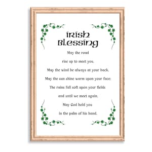May include: A framed print with a white background and a green shamrock border. The print features an Irish blessing that reads: "May the road rise up to meet you. May the wind be always at your back. May the sun shine warm upon your face: The rains fall soft upon your fields and until we meet again. May God hold you in the palm of his hand."