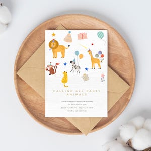 May include: A white invitation card featuring a colourful illustration of animals, stars and party hats. The text reads "Calling All Party Animals" and includes details for a first birthday party.