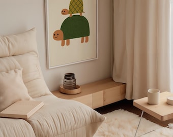 May include: A framed illustration of two green turtles with brown accents. The smaller turtle is on top of the larger turtle. The illustration is on a cream background with a white frame.