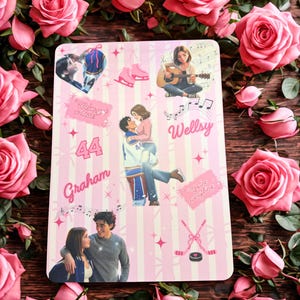 May include: A rectangular print featuring a light pink striped background with various illustrations including a couple embracing, a person playing guitar, ice skates, hockey sticks, and text reading Graham, 44, Wellsy, and You're everything.