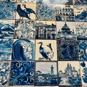 May include: A collection of square ceramic tiles with blue and white designs. The tiles feature various images, including birds, architectural structures, and wave patterns. The overall aesthetic is reminiscent of traditional Portuguese Azulejo tiles.