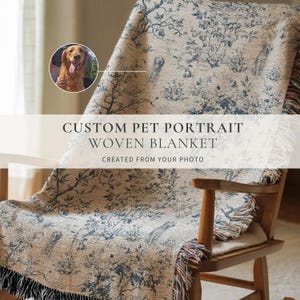 May include: A woven blanket with a custom pet portrait design, draped over a wooden rocking chair. The blanket features a cream-colored background with a blue floral pattern and the text "CUSTOM PET PORTRAIT WOVEN BLANKET CREATED FROM YOUR PHOTO."