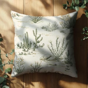 May include: A white throw pillow with a green and brown desert plant pattern. The pillow is made of a soft, comfortable fabric and features a subtle, elegant design.