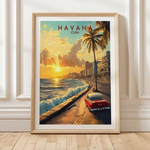 May include: A framed art print depicting a sunset over the Havana coastline. The artwork includes a red classic car, palm trees, and the text "HAVANA CUBA" in red. The scene is painted with warm colours, evoking travel and nostalgia.