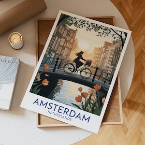 Amsterdam Netherlands Travel Poster Featuring Woman Cycling on Bridge at Sunrise with Tulips and Traditional Canal Houses View, Travel Gift