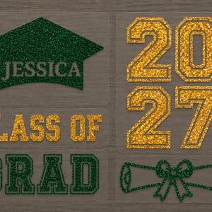 May include: A set of graduation-themed iron-on transfers featuring a dark green glitter mortarboard with the name JESSICA, the gold glitter numbers 2027, the gold glitter text CLASS OF, the dark green glitter text GRAD, and a green glitter diploma.