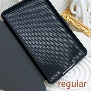 May include: A black case with a honeycomb pattern on the back. The case is open and the inside is black. The word "regular" is printed on the bottom right corner of the image.