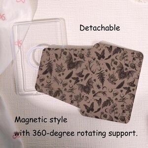 May include: A detachable phone case with a brown pattern featuring bats, butterflies, and other gothic elements. The case has a magnetic style with 360-degree rotating support. A clear case is visible on the left.