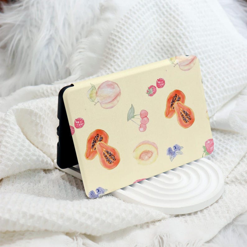 May include: A yellow phone case with a watercolor design of fruit, including papaya, peaches, and raspberries.