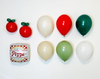 May include: A collection of balloons and decorative items, including red tomato-shaped ornaments with green stems, and a pizza-themed foil balloon. The balloons are in various colors: white, red, green, and beige. The pizza balloon has the text "Pizzu".