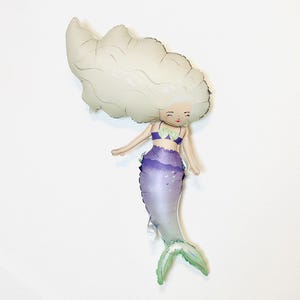 May include: A white and purple mermaid balloon with a light green tail. The mermaid has a white crown and a purple seashell bra.