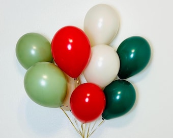 May include: A bouquet of nine balloons in various colors, including red, green, and white. The balloons are tied together with gold string, creating a festive arrangement. The balloons are round and shiny, perfect for a celebration.