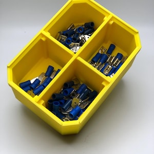 May include: A white ceramic mug with a black handle and the text "But First, Coffee" in a black, bold font. The mug is sitting on a white surface.