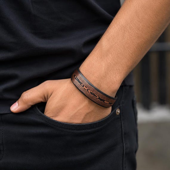 Hand-forged Damascus-style copper cuff using Mokume-Gane technique — a genuinely ancient Japanese metalsmithing art that produces wild, wood-grain-like patterns impossible to fake with mass production.