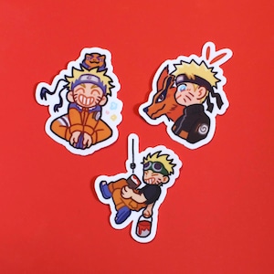 May include: Three anime-style stickers featuring a character with spiky blonde hair and orange clothing. One sticker shows the character smiling, another with a fox, and the last one holding a paint bucket. The stickers are on a red background.