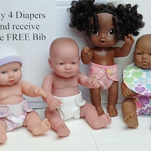 May include: Four baby dolls of varying skin tones wearing cloth diapers. One doll wears a white hat, one wears a pink floral diaper, and one wears a heart-patterned bib and diaper. A sign reads: Buy 4 Diapers and receive one FREE Bib.