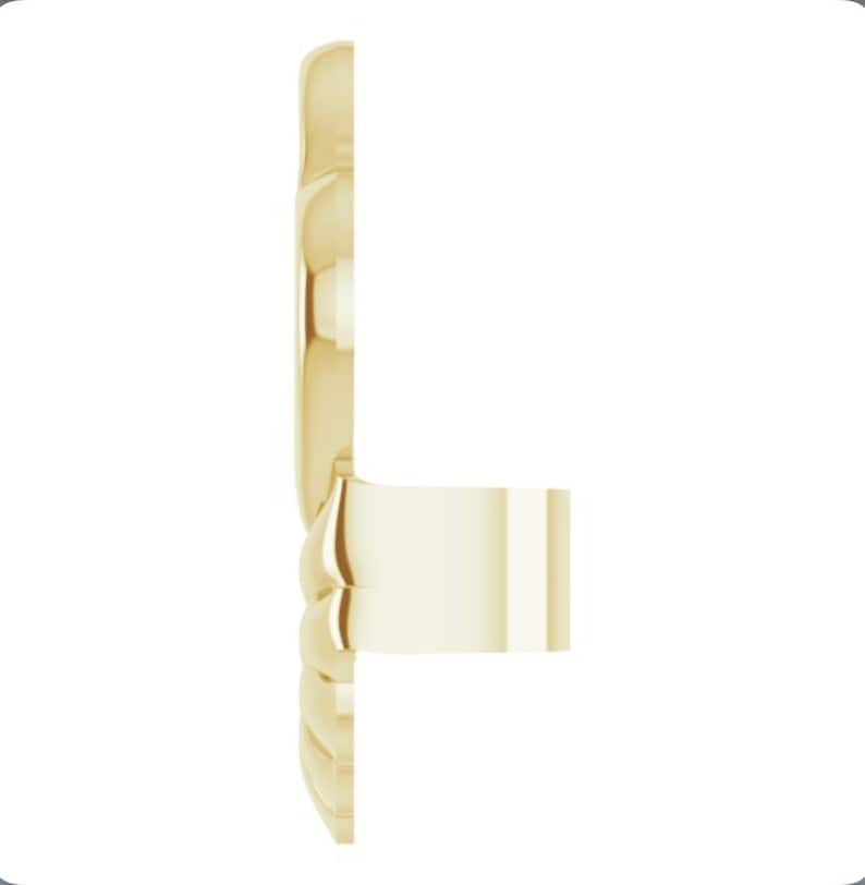 May include: A gold-toned ring with a textured band and a smooth, flat top.