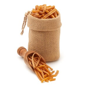 May include: A burlap sack filled with orange pasta, with a wooden scoop holding more pasta. The pasta is a light orange color and has a ridged texture. The sack is tied with a natural-colored string.