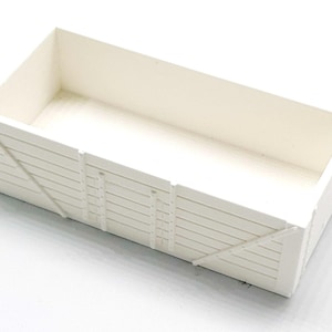 May include: White wooden box with a rectangular shape and a slatted design. The box is empty and has a smooth, white finish.
