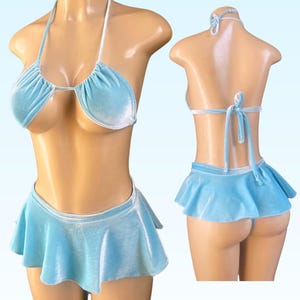 May include: A light blue velvet bikini set with a halter top and a ruffled skirt. The top has a plunging neckline and the skirt is short and flirty.