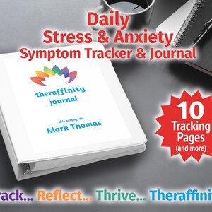 May include: A white binder with a rainbow lotus flower design and the text "theraffinity journal" on the cover. The binder has a personalised label that says "this belongs to: Mark Thomas". A red starburst with the text "10 Tracking Pages (and more)" is in the lower right corner. The text "Track... Reflect... Thrive... Theraffinity" is at the bottom of the image.