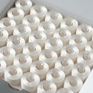 Size a pre-wound plastic bobbins - white embroidery thread