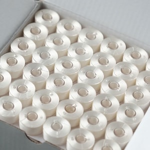 Size l pre-wound plastic bobbins - white embroidery thread