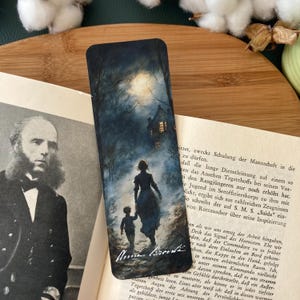 May include: A watercolour bookmark depicting a woman and a child walking towards a house in the distance. The scene is set at night with a full moon in the sky. The bookmark is signed "Anna Bronk" in the bottom right corner.