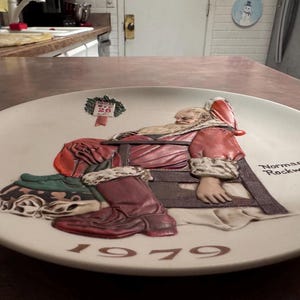Norman Rockwell Christmas plate. “the morning after Christmas”