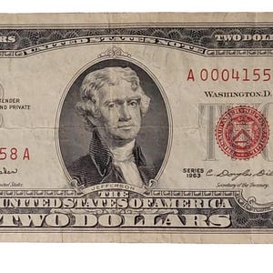 May include: A two dollar bill with a portrait of Thomas Jefferson and the text "A 00041558 A" printed in red.