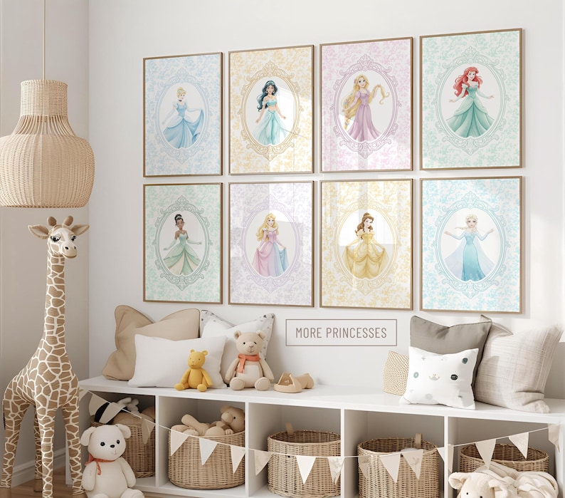May include: Eight framed princess art prints in pastel colors, each featuring a different princess in an oval frame. The prints are displayed on a white wall above a white shelf with decorative items and baskets. The text "MORE PRINCESSES" is visible.