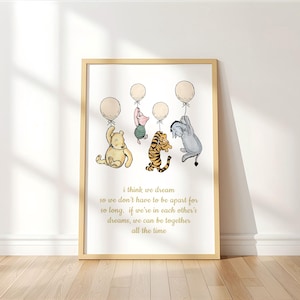 May include: A framed print featuring Winnie the Pooh characters holding balloons. The characters include Winnie the Pooh, Piglet, Tigger, and Eeyore. The print has a light wood frame and includes the text "i think we dream so we don't have to be apart for so long..."