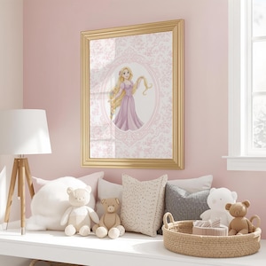May include: A framed print featuring a princess in a pink dress with long blonde hair. The artwork is set against a pink floral background and framed in gold. The scene is in a child's bedroom with stuffed animals and a lamp.
