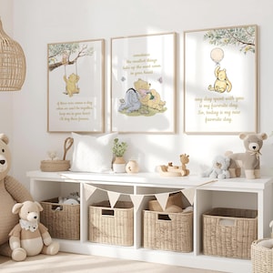 May include: Three framed Winnie the Pooh art prints with quotes in a nursery setting. The prints feature illustrations of Pooh and friends. The room includes a white shelf with woven baskets, stuffed animals, and decorative items.
