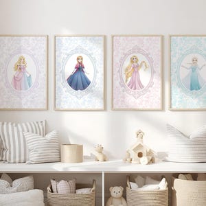 May include: Four framed art prints featuring princess illustrations in oval frames. Each princess is depicted in a colorful gown against a patterned background. The frames are displayed above a white shelf with decorative items.