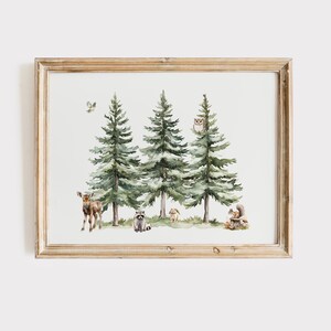 May include: Watercolor print of a forest scene with three tall green pine trees. A deer, raccoon, rabbit, and squirrel are among the trees. An owl sits in one of the trees, and a bird flies above. The artwork is in a light brown wooden frame.