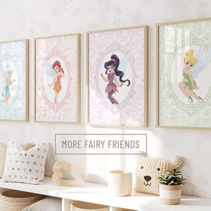 May include: Four framed wall art prints featuring illustrated fairies in oval frames with ornate borders. Each print displays a different fairy character in a unique colour palette of blue, orange, purple, and green. The text MORE FAIRY FRIENDS is visible.