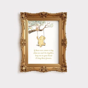 May include: A framed print featuring a watercolor illustration of Winnie the Pooh and Piglet on a swing. The gold frame surrounds the image and includes the quote: "If there ever comes a day when we can't be together, keep me in your heart I'll stay there forever."