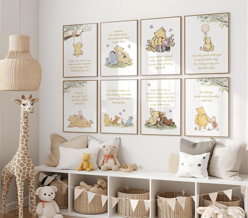 May include: A collection of framed Winnie the Pooh art prints with inspirational quotes and illustrations. The prints feature characters like Pooh, Piglet, and Eeyore in various scenes. The artwork is displayed above a white shelf with stuffed animals and woven baskets.