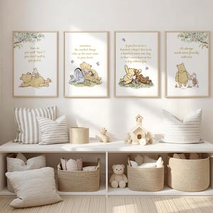 May include: Four framed Winnie the Pooh art prints with quotes and illustrations. The prints are displayed above a white shelf with baskets, pillows, and decorative items. The art features soft colors and whimsical designs.