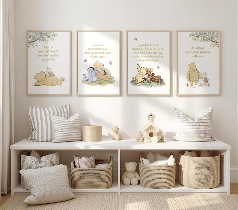 May include: Four framed Winnie the Pooh art prints with quotes and illustrations. The prints are displayed above a white shelf with baskets, pillows, and decorative items. The art features soft colors and whimsical designs.