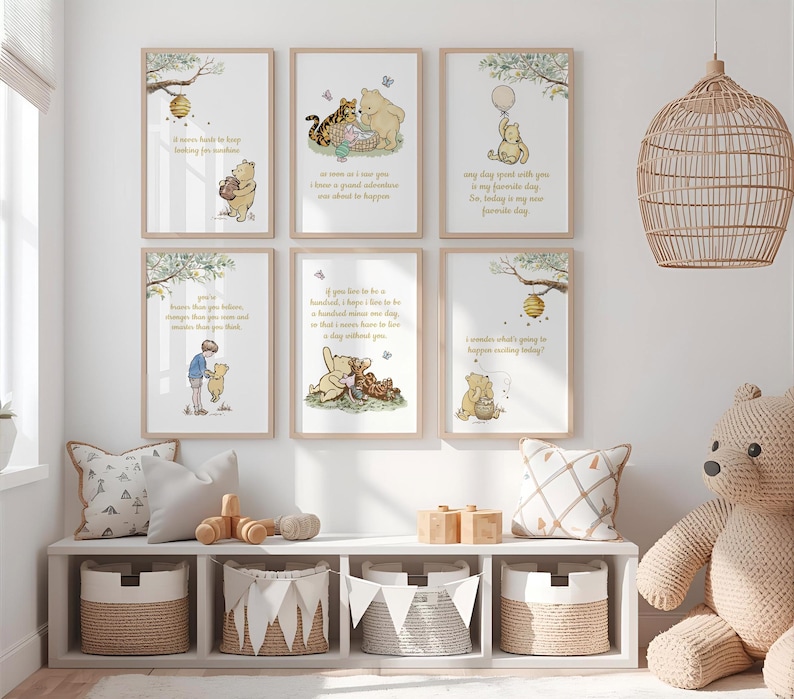 May include: A set of six framed Winnie the Pooh art prints with quotes. The prints feature illustrations of Pooh, Tigger, and Piglet. The prints are displayed above a white shelf with baskets, pillows, and a wooden toy.