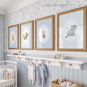 May include: Four framed wall art prints featuring Winnie the Pooh characters, including Pooh, Tigger, Piglet, and Eeyore, displayed in gold frames. Each print is set against a light blue background with white scalloped oval borders.