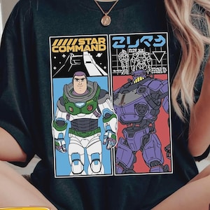 May include: Black t-shirt with a graphic of two characters from a science fiction movie. One character is in a green and white spacesuit, and the other is a purple robot. The shirt has the words "STAR COMMAND" and Japanese text.