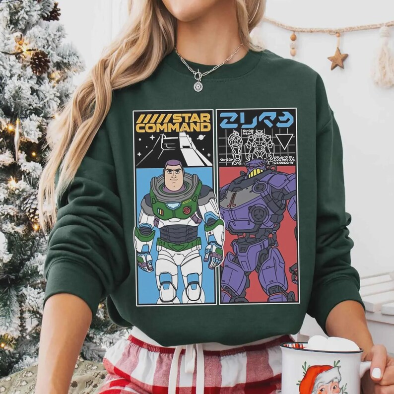 May include: Dark green sweatshirt with a graphic design. The left panel says "STAR COMMAND" and features a cartoon character in a space suit. The right panel has Japanese text and a purple robot.