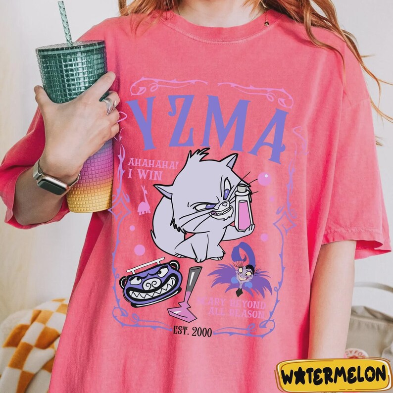 May include: Pink t-shirt with a purple graphic of a cat holding a potion, the word "Yzma", and the text "AHAHAHA! I WIN". Additional graphics include a monster, a lightning bolt, and the text "EST. 2000".