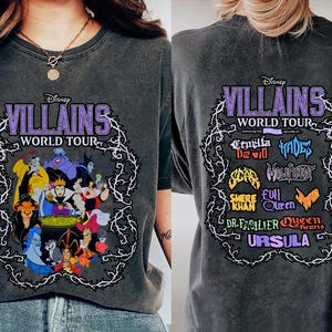 May include: Dark gray t-shirt featuring the text "Disney Villains World Tour" in purple, with a white vine border. The front displays various Disney villains. The back shows the tour's lineup, including Cruella De Vil and Ursula.